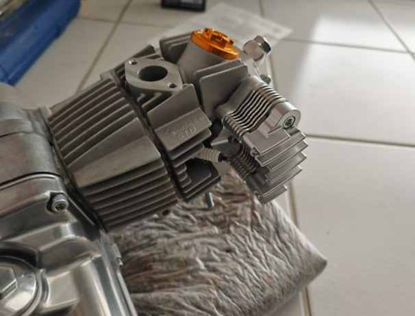 Metallic engine block on a towel with a tiled floor background
