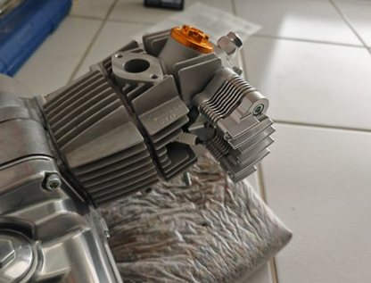 Metallic engine block on a towel with a tiled floor background