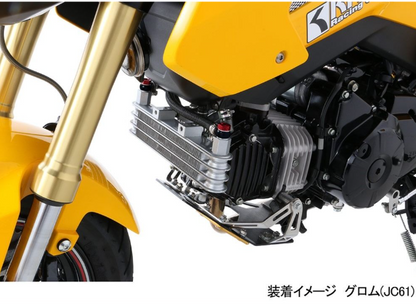 Close-up of a yellow motorcycle with visible branding on a white background