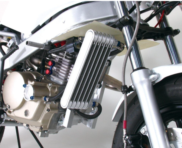 Close-up of a motorcycle engine and cooling system on a white background