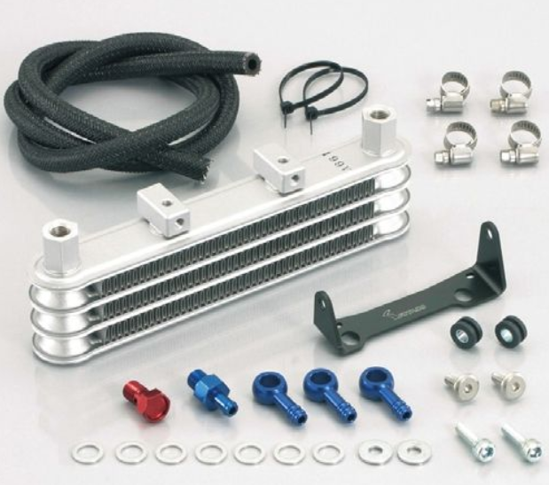 Collection of automotive parts including a metal heat exchanger, hoses, and various small components on a white background.