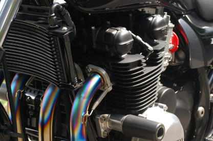 Close-up of a motorcycle engine with colorful pipes