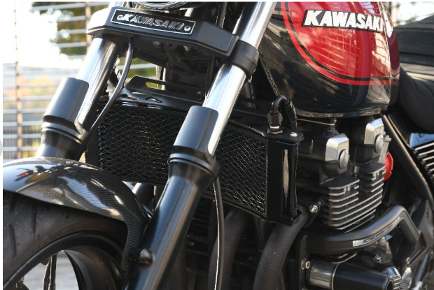 Close-up of a Kawasaki motorcycle with focus on the engine and branding.