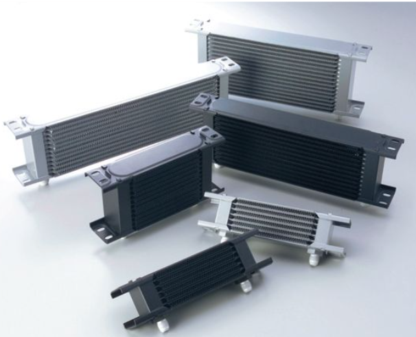 Collection of metal heat exchangers on a white background