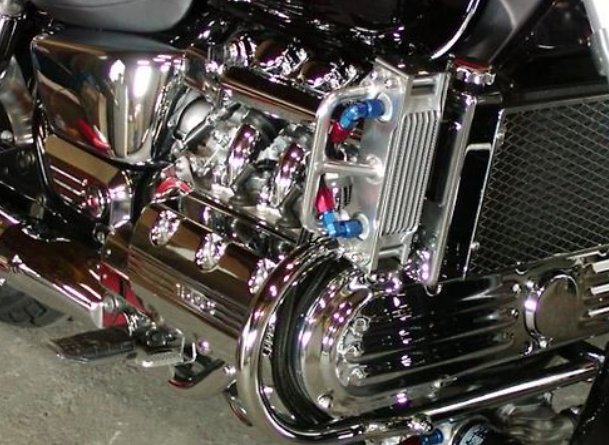 Close-up of a motorcycle engine with chrome and metallic components.