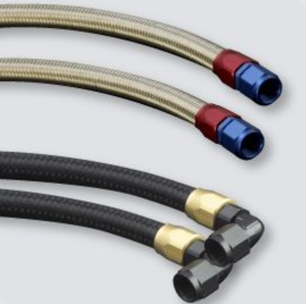 Three flexible hoses with metal connectors on a light gray background
