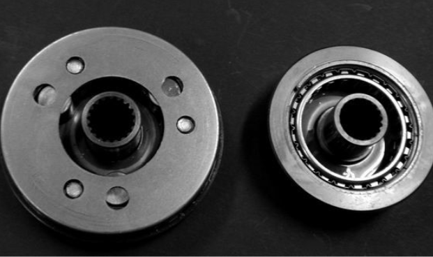 Two mechanical components on a black background