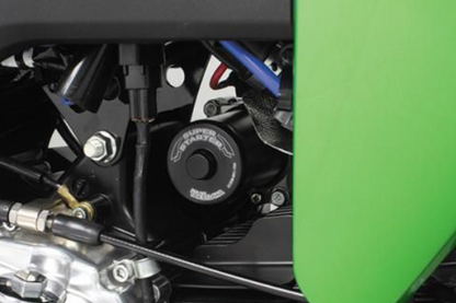 Close-up of a motorcycle engine with a green background