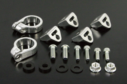Set of metal hardware components including clamps, bolts, and nuts on a black background