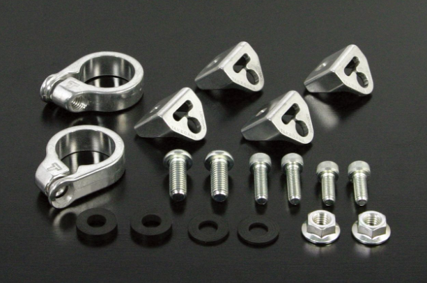 Set of metal hardware components including clamps, bolts, and nuts on a black background
