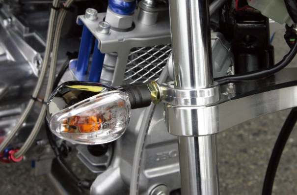 Close-up of a motorcycle's headlight and front suspension