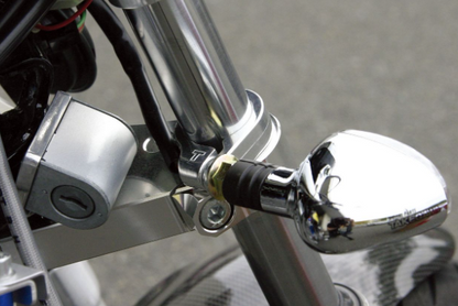 Close-up of a motorcycle mirror and lock mechanism.