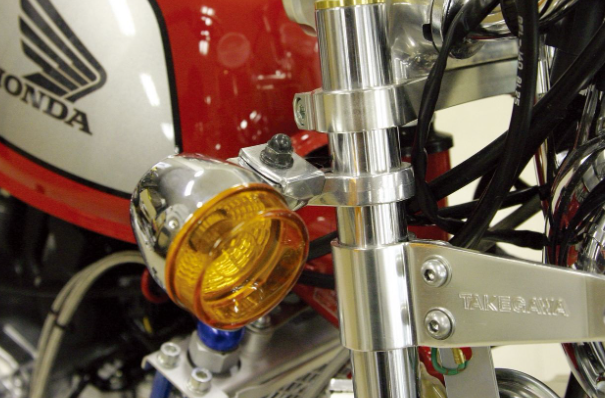 Close-up of a motorcycle with a yellow turn signal and Honda branding.