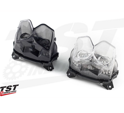 Two motorcycle headlights on a white background with TST Industries logo.