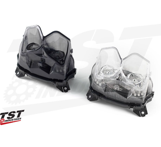Two motorcycle headlights on a white background with TST Industries logo.