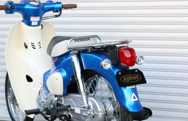 Blue Honda motorcycle with Kijima branding against a white background