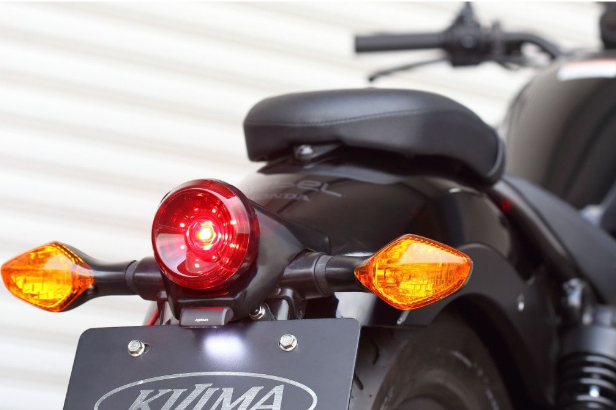Close-up of a motorcycle's taillight and turn signals with KTM branding.