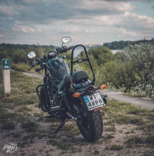 Motorcycle parked on a dirt road with a scenic background