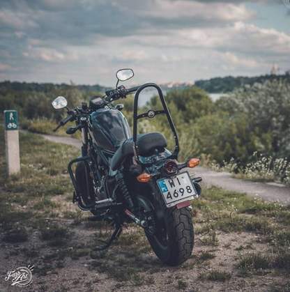 Motorcycle parked on a dirt road with a scenic background