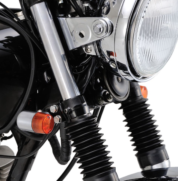 Close-up of a motorcycle's headlight and front suspension on a white background
