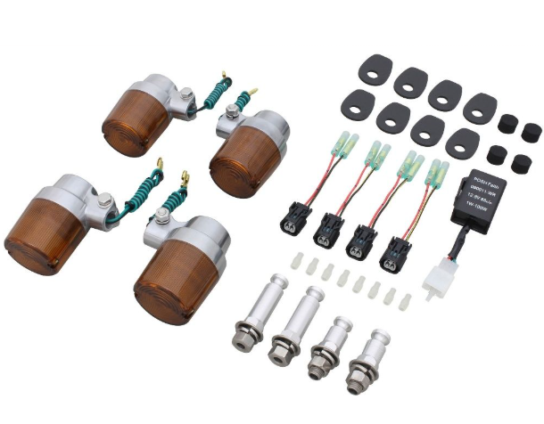 Collection of automotive parts including lights and connectors on a white background