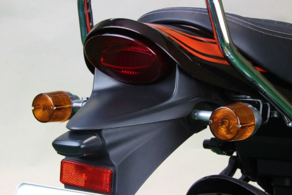 Close-up of a motorcycle's rear lights and reflectors on a plain background