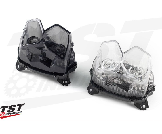 Two motorcycle headlights on a white background with TST Industries logo.