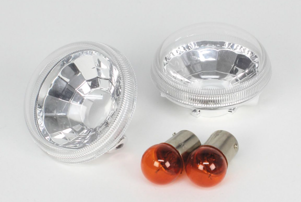 Two car headlights and two orange bulbs on a white background