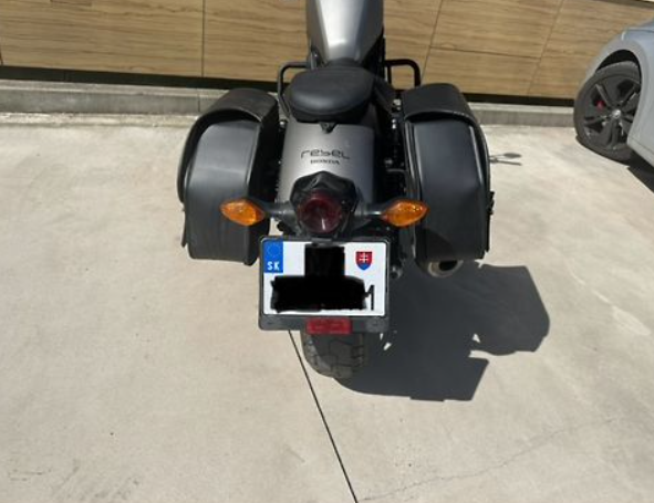 Motorcycle with a visible license plate on a concrete surface