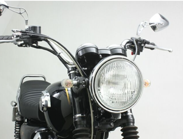 Close-up of a motorcycle's headlight and handlebars on a light gray background