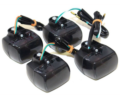 Four black electronic components with wiring on a white background