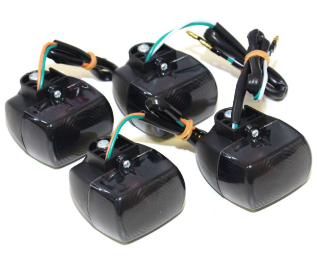 Four black electronic components with wiring on a white background