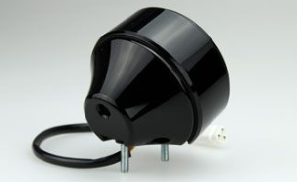 Black cylindrical electronic component on a white background
