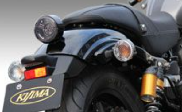 Close-up of a motorcycle with KTM branding on a gray background