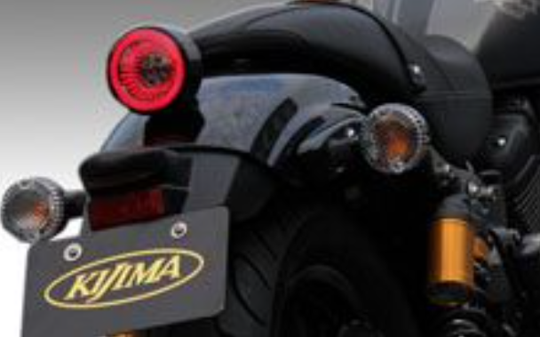 Close-up of a motorcycle with KIJIMA branding on a gray background