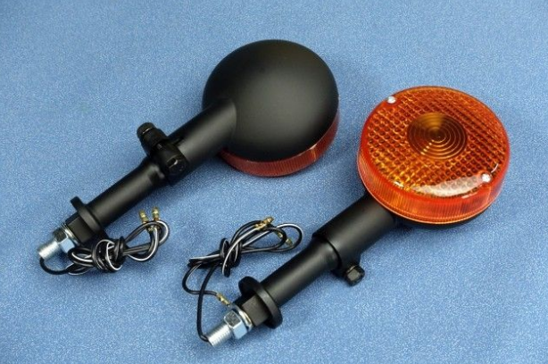 Two motorcycle mirrors with orange reflectors on a blue background