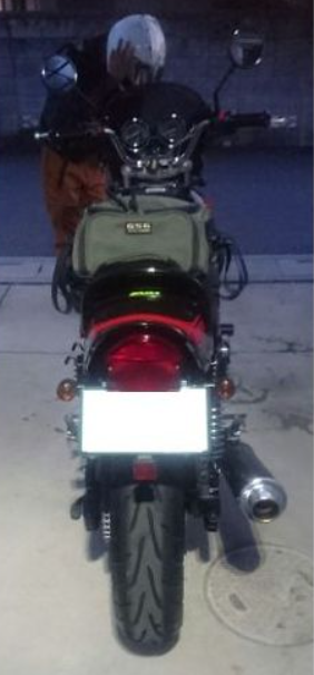 Motorcycle with a person wearing a helmet inside, on a plain background