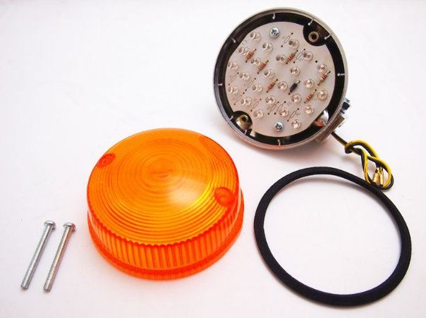 Orange warning light assembly with metal components on a white background