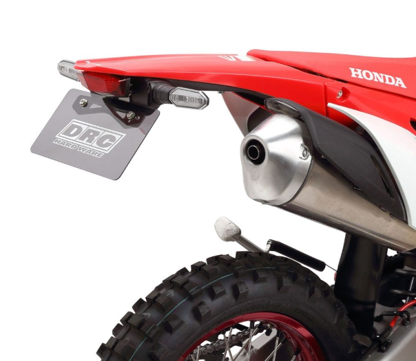 Close-up of a red Honda dirt bike with DRZ branding on a white background