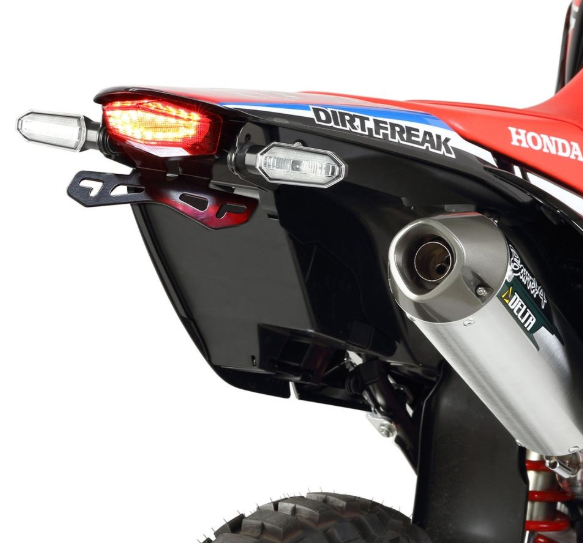 Close-up of a Honda dirt bike with visible branding on a white background