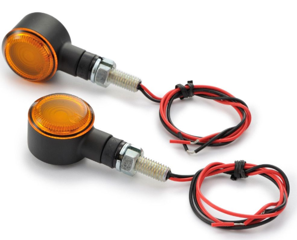 Two motorcycle turn signals with wiring on a white background