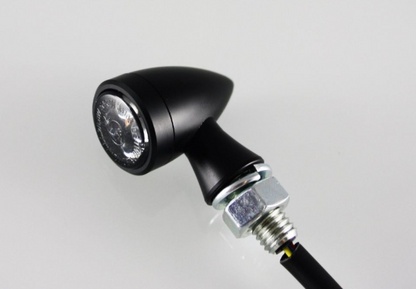 Black motorcycle light on a gray background