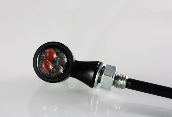 Mechanical pressure gauge with black casing and red and silver face on a white background