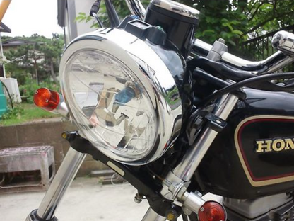 Close-up of a motorcycle headlight with a blurred background