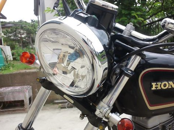 Close-up of a motorcycle headlight with a blurred background