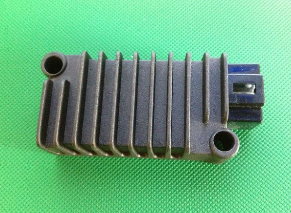 Metallic heat sink on a green textured background