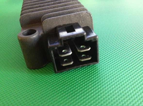 Black electrical connector on a green textured background