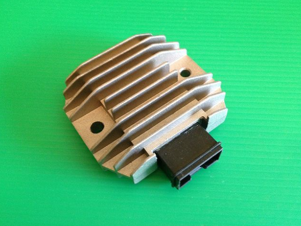 Metallic electronic component on a green background