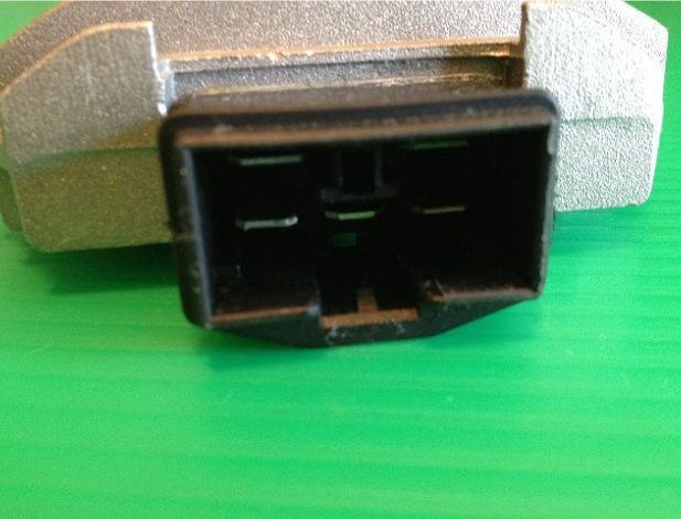 Black electrical connector on a green surface