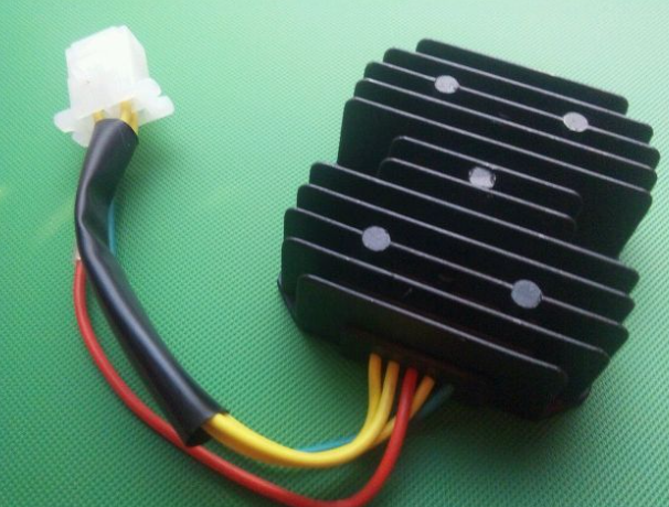 Black electronic component with wires on a green background